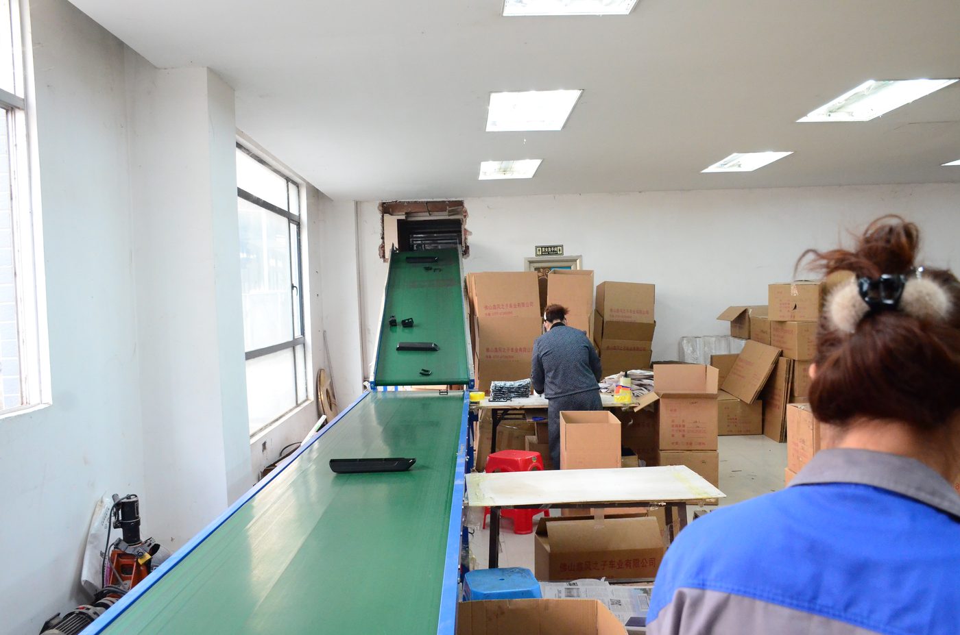 Assembly and packing stations where battery cases are finished and boxed