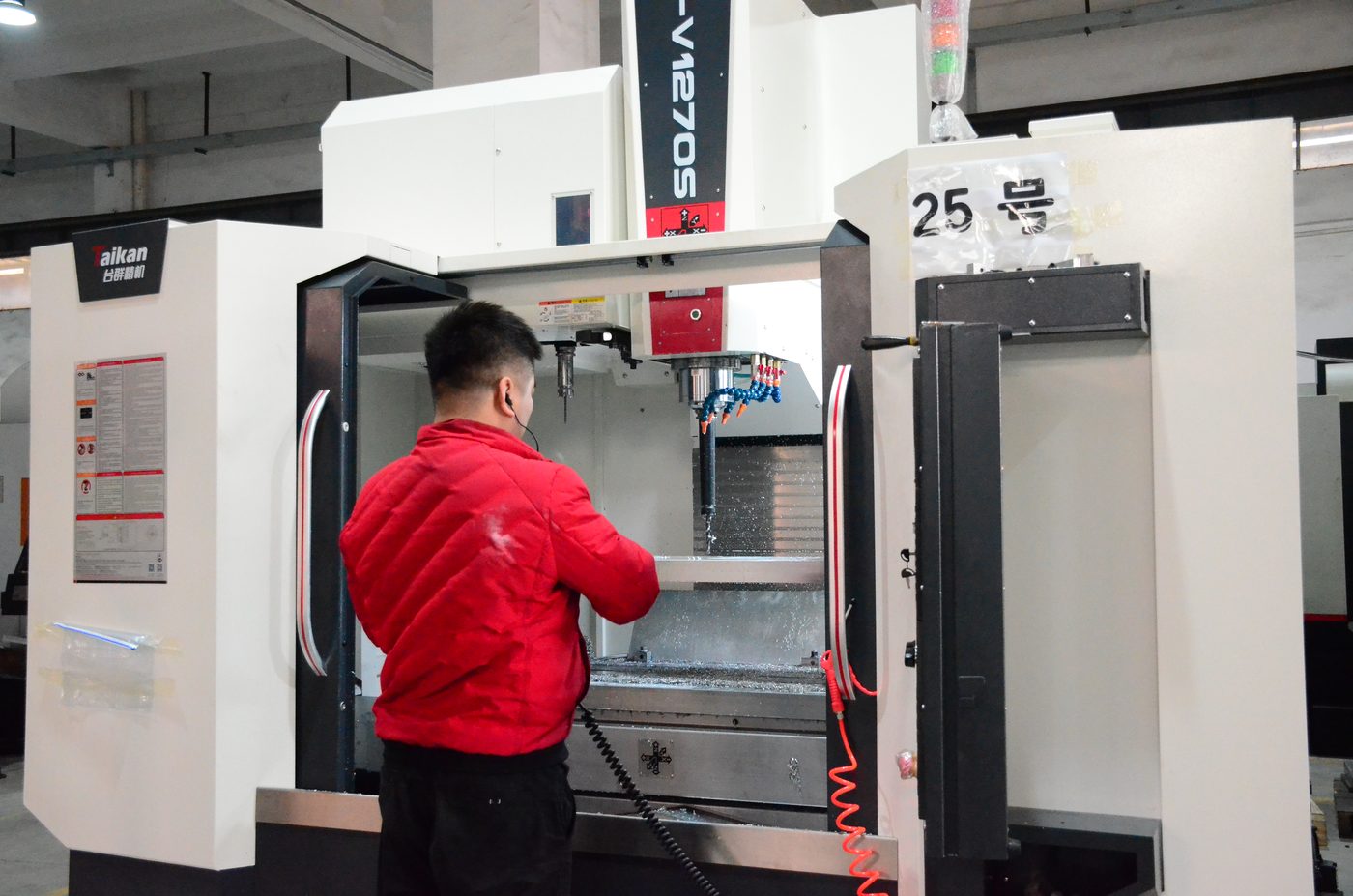Operator setting up a machining centre on the ALX production floor in Guangzhou